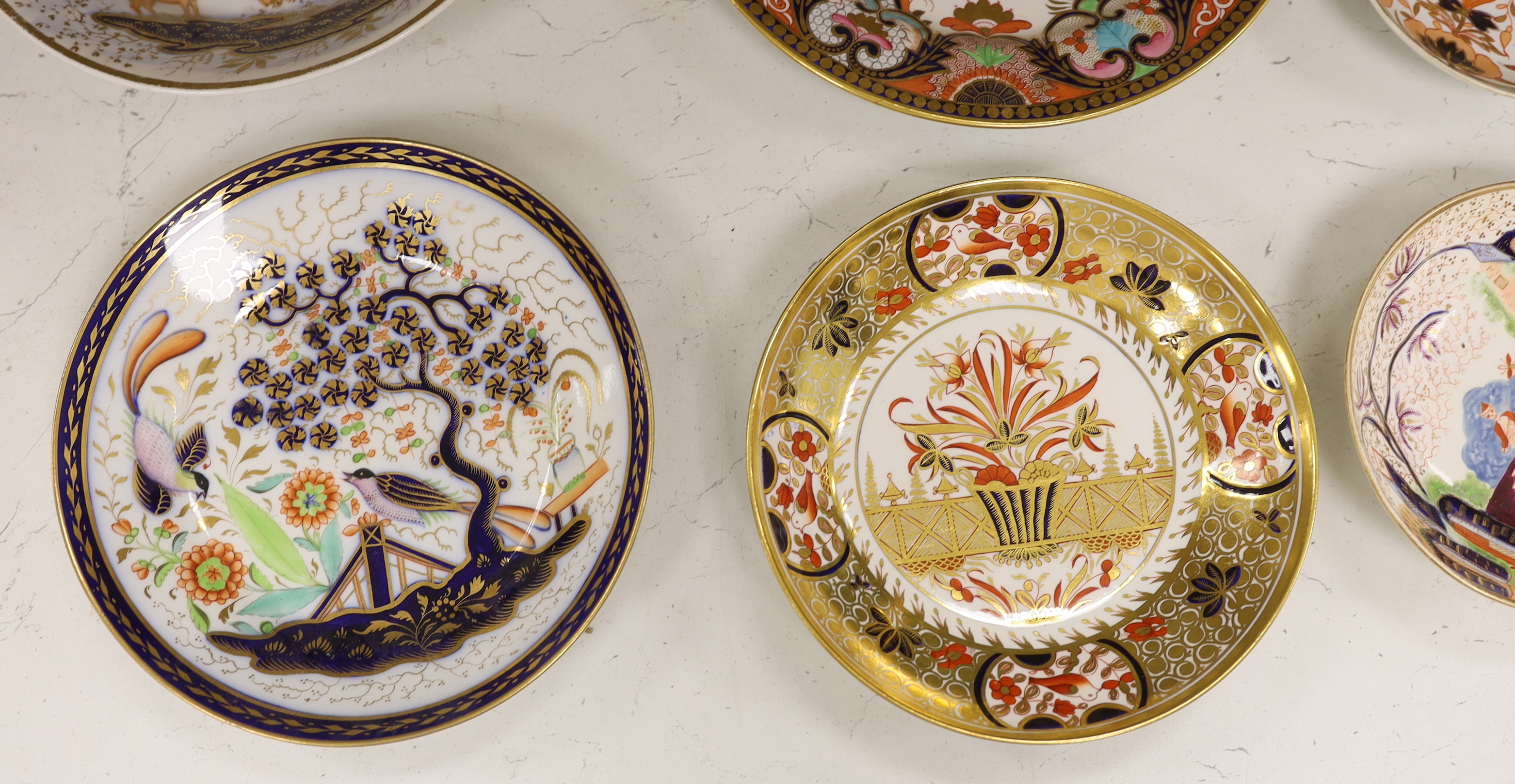 Sixteen mixed items of 1800-1820 English porcelain tableware, to include: three sucriers and covers, an oval ornately decorated dish, four saucer dishes, a candle holder, three spill vases and four saucers